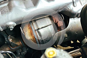 Catalytic converter on diesel engine in a car, close up a car catalytic converter for filtration carbon monoxide.