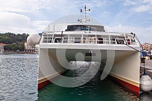 Catamaran anchors in the harbor