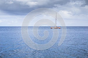 Catamaran in the bay near coast of the city Fort-de-France