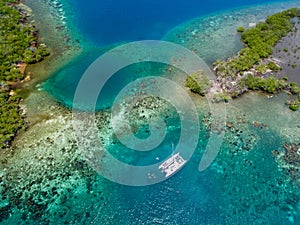 Catamaran in coral reef on coast of Belize