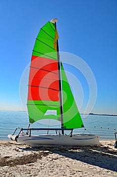 Catamaran With Green and Red Sails