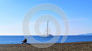 Catamaran on the Mediterranean with peaceful beach chair guy photo
