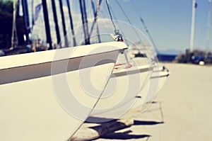 Catamaran sailboats stranded in a beach, with a filter effect