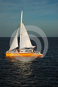 Catamaran at sea in the sunset