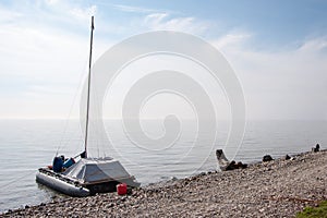 Catamaran on the shore of Lake Baikal with light fog.