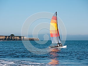 Catamaran sport sailing, red sail