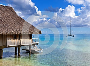 Catamaran and wooden hut at the sea.