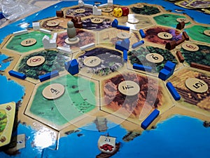 Catan The Settlers of Catan - a family teamwork board game with buildings and roads  - One of the Best selling games