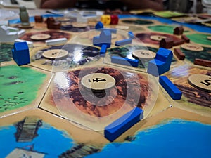 Catan The Settlers of Catan - a family teamwork board game with buildings and roads  - One of the Best selling games photo