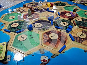 Catan The Settlers of Catan - a family teamwork board game with buildings and roads  - One of the Best selling games photo