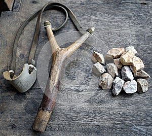 Catapult with stones on wood background