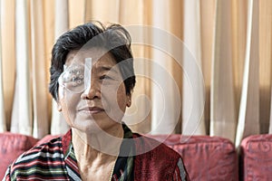 Cataract elderly patient, Asian old senior woman having eye care treatment on Age-related eye diseases, AMD photo