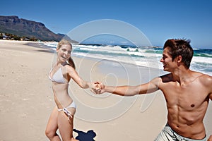 Catch me if you can. a happy young couple enjoying a playful moment at the beach.