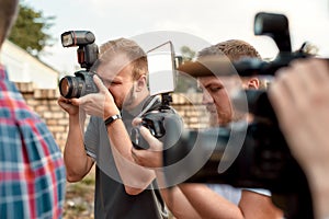 Catch the moment. Male photographers taking photos with DSLR digital cameras. Journalism industry