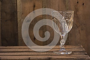 Cristal glass masterpiece on old wooden table photo