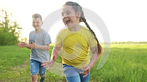 catch-up. children kid dream together run in the park at sunset. happy family people in park concept. boy and girl