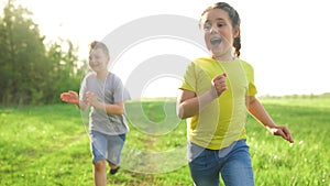 Catch-up. children kid dream together run in the park at sunset. Happy family people in park concept. Boy and girl