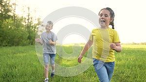 catch-up. children kid dream together run in the park at sunset. happy family people in park concept. boy and girl