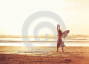 Catch your dreams. a young woman enjoying a day at the beach.