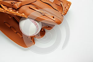 Catcher`s mitt and baseball ball on white background, top view with space for text. Sports game