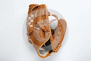 Catcher's mitt and baseball ball on white background, top view. Sports game