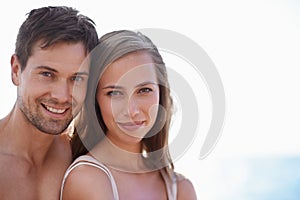 Catching the last of the summer rays. Closeup portrait of a happy couple at the beach.