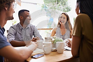 Catching up with old friends. Shot of a group of friends talking in a cafe.