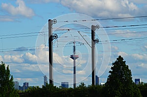 Catenary masts frame the Frankfurt TV tower. photo