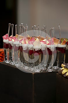 Catered grouping of champaigne glasses with fruit and sweets for a wedding event
