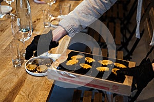 Caterer Arranging Gourmet Tartlets for Event photo