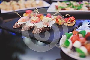 Catering banquet table with different food snacks and appetizers on corporate christmas birthday party event