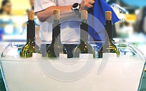 Catering bartender Italian fine wine bottles winetasting session sommelier waiter serving wine people clean glasses photo