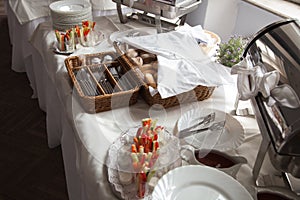 Catering. A bread basket with Cutlery and snacks for cocktail parties