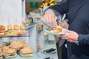 Catering buffet table with food and snacks for guests of the event. Group of people in all you can eat. Dining Food Celebration Pa