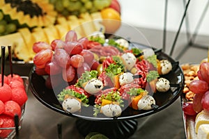 Catering buffet table with snacks and appetizers. Set of varios fruits and berries. Wedding event photo