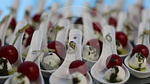 Catering. Close up of a plate of classic Italian caprese salad on a skewer.