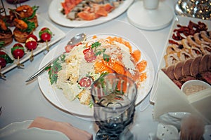 Catering. Off-site food. Banquet table with portioned salads with salmon