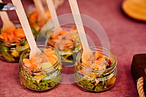 Catering. portioned serving of dishes. fish and avocado pate in small glass jars