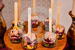 Catering. portioned serving of dishes. pate with salad in small glass jars.