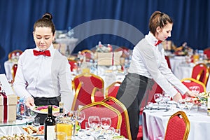 Catering restaurant waitress serving table with food