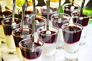 Catering Service Concept: Berry Mousse Pudding Parfait In The Glass Shots With Spoons Served at a Business Event, Hotel, Birthday