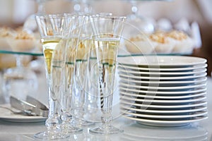 Catering services. Glasses with wine in row background at restaurant party.