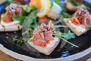 Catering table with salmon bruschetta, beautifully decorated banquet with food snacks appetizers on corporate birthday party event
