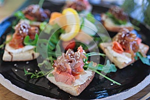 Catering table with salmon bruschetta, beautifully decorated banquet with food snacks appetizers on corporate birthday party event