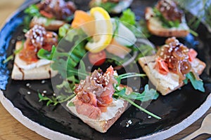 Catering table with salmon bruschetta, beautifully decorated banquet with food snacks appetizers on corporate birthday party event