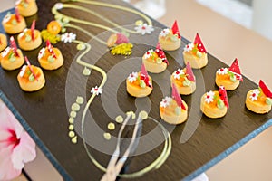 The catering wedding buffet. Wedding reception dessert table with delicious decorated white cupcakes with berries closeup