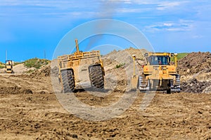 Caterpillar bulldozer is in the middle of a construction site