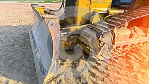 Caterpillar of large tractor. ron track of large tractor for driving on sand and mud Detail of yellow gears