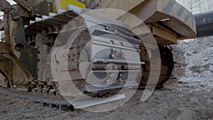 Caterpillar tracks close up shot. Super close up view of power tractor track wheels spinning and moving on ground