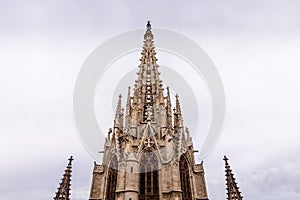 The Cathedral of Barcelona, detail of the main spire in typical gothic style with stone friezes and gargoyles. Barri Gotic,